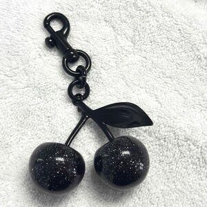 All black cherry charm.  Not Coach brand. Excellent condition.  Quick shipper.